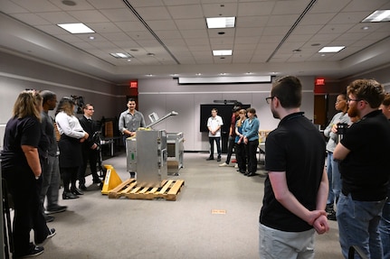 Seniors from George Mason University visited Naval Surface Warfare Center, Carderock Division, to present their senior design projects to Carderock engineers on May 9, 2024. The two teams presented their projects; one team built an environmental chamber for mechanical testing and the other was tasked with fabricating composite panels for ready service lockers that were malleable enough to bend 45 degrees on all four corners and edges. Carderock, the Navy's ship design and innovation powerhouse, provides the technical foundation for the future fleet through world-class research, development, and testing. (U.S. Navy Photo by Chalene Simmons)