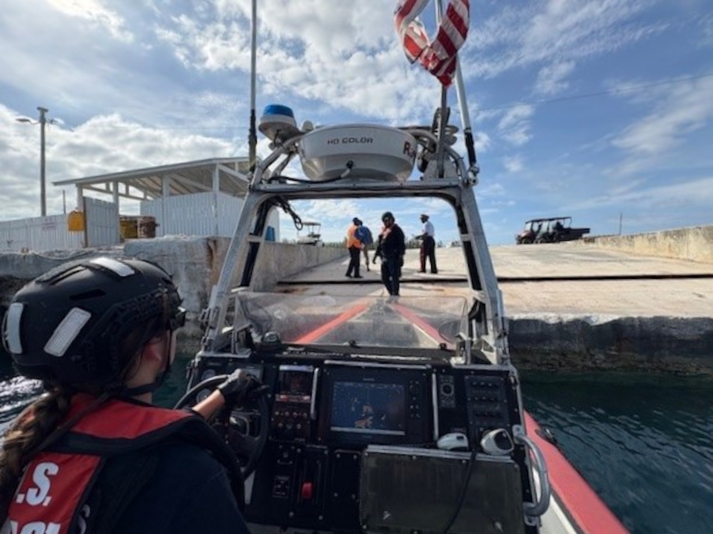 A boat crew from the Coast Guard Cutter Margaret Norvell (WPC-1105) mooring alongside a pier in Freeport, Bahamas, May 30, 2025. The crew transferred the survivor to the Royal Bahamas Defense Force after he was rescued from a capsized vessel approximately eight miles offshore. (U.S. Coast Guard photo)