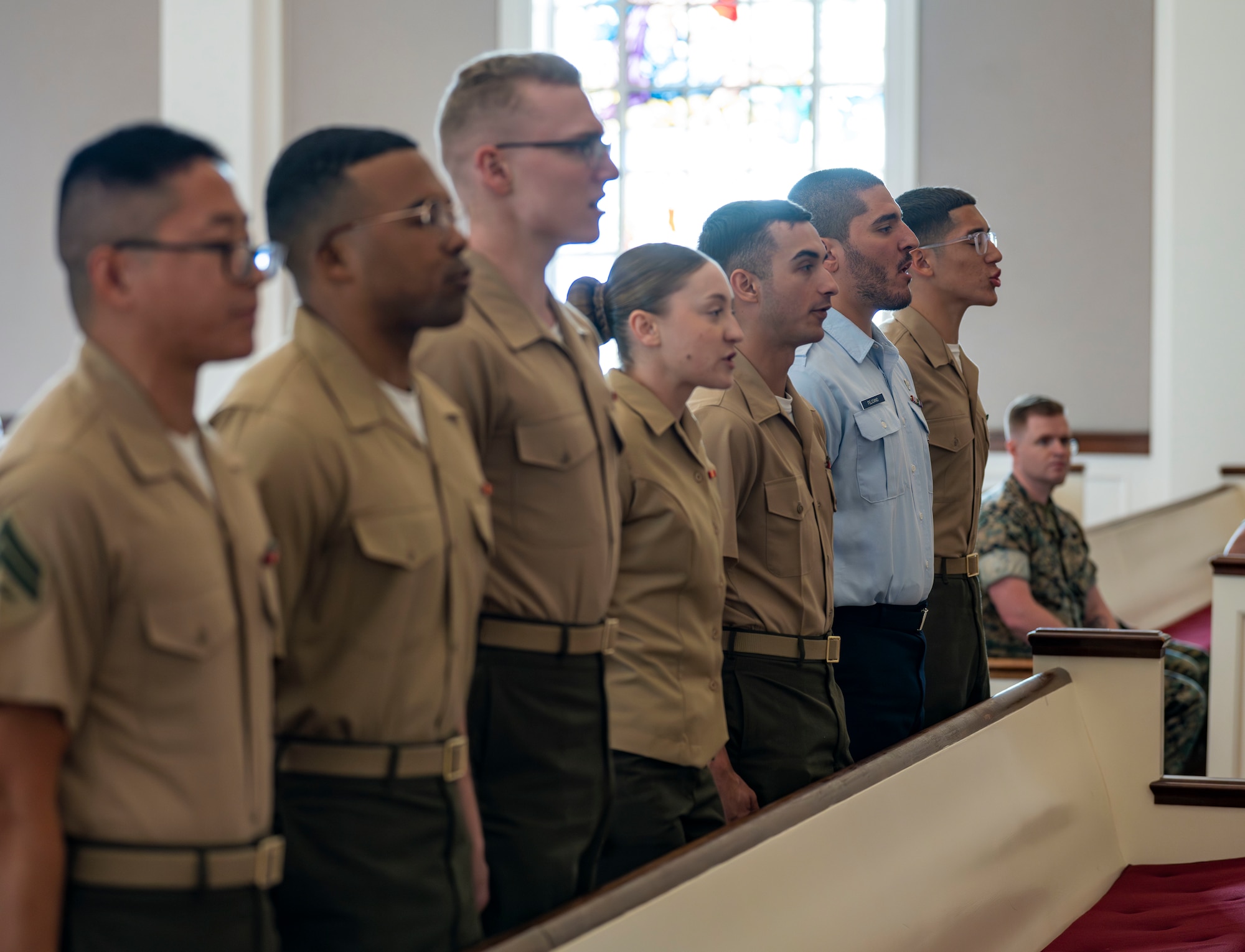 U.S. Marines and an Airman, 2nd from the right, recite the Noncommissioned Officer’s Creed during a Corporals Course graduation.