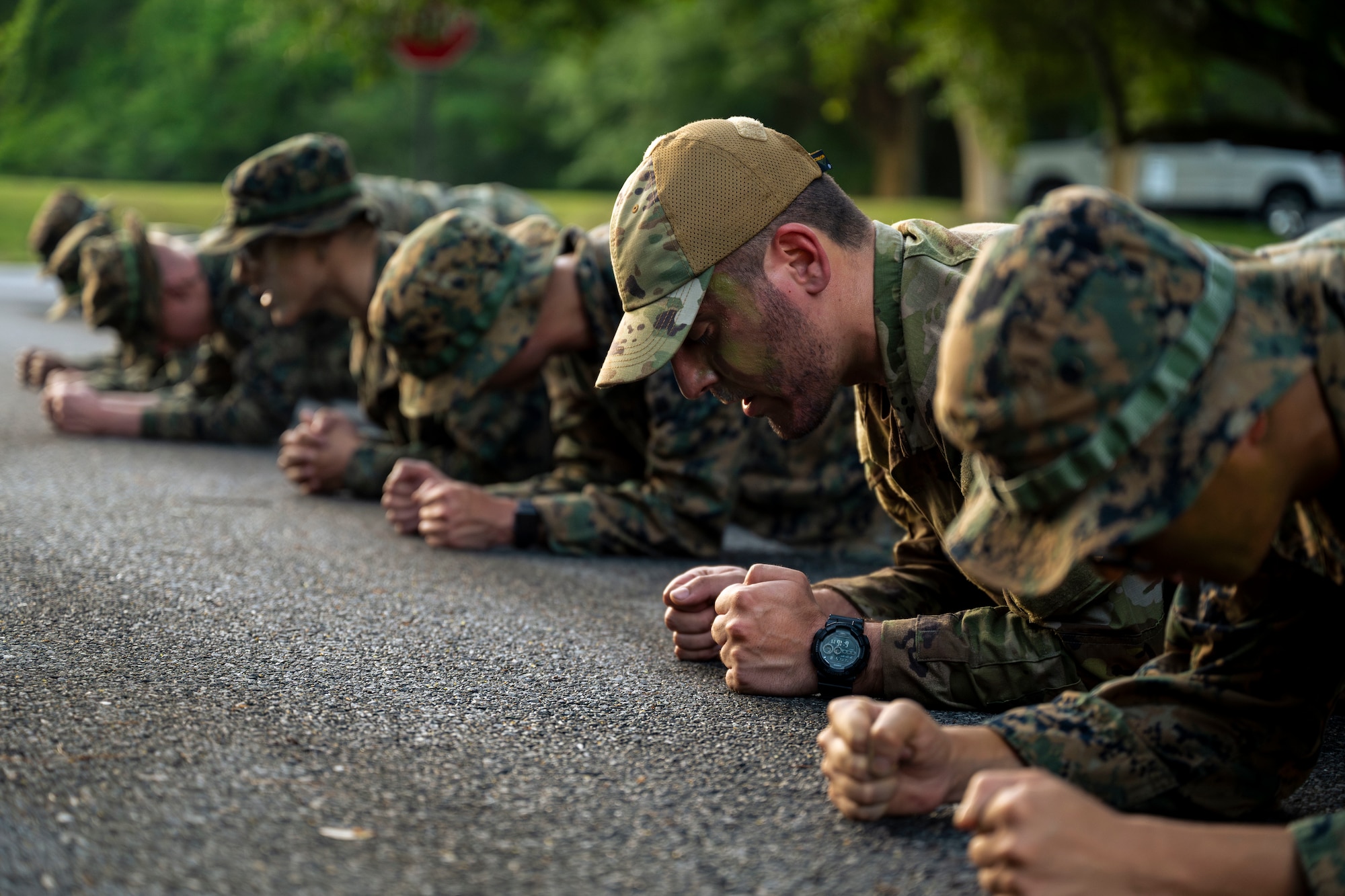 U.S. Marines and an Airman perform a plank hold.
