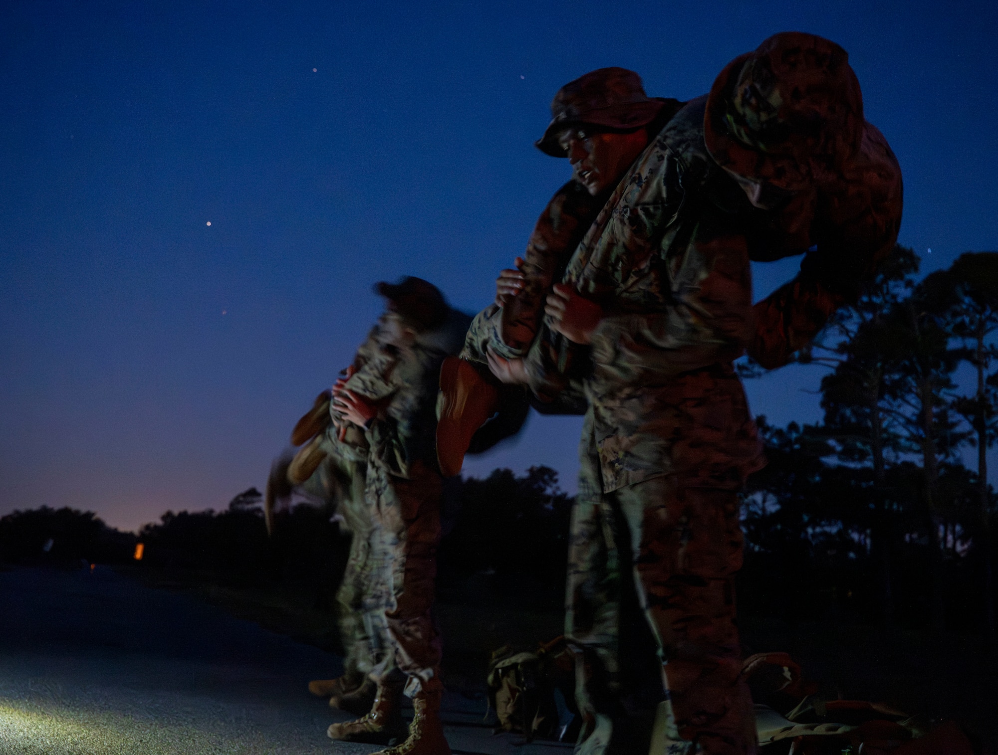 Two marines perform a fireman's carry.