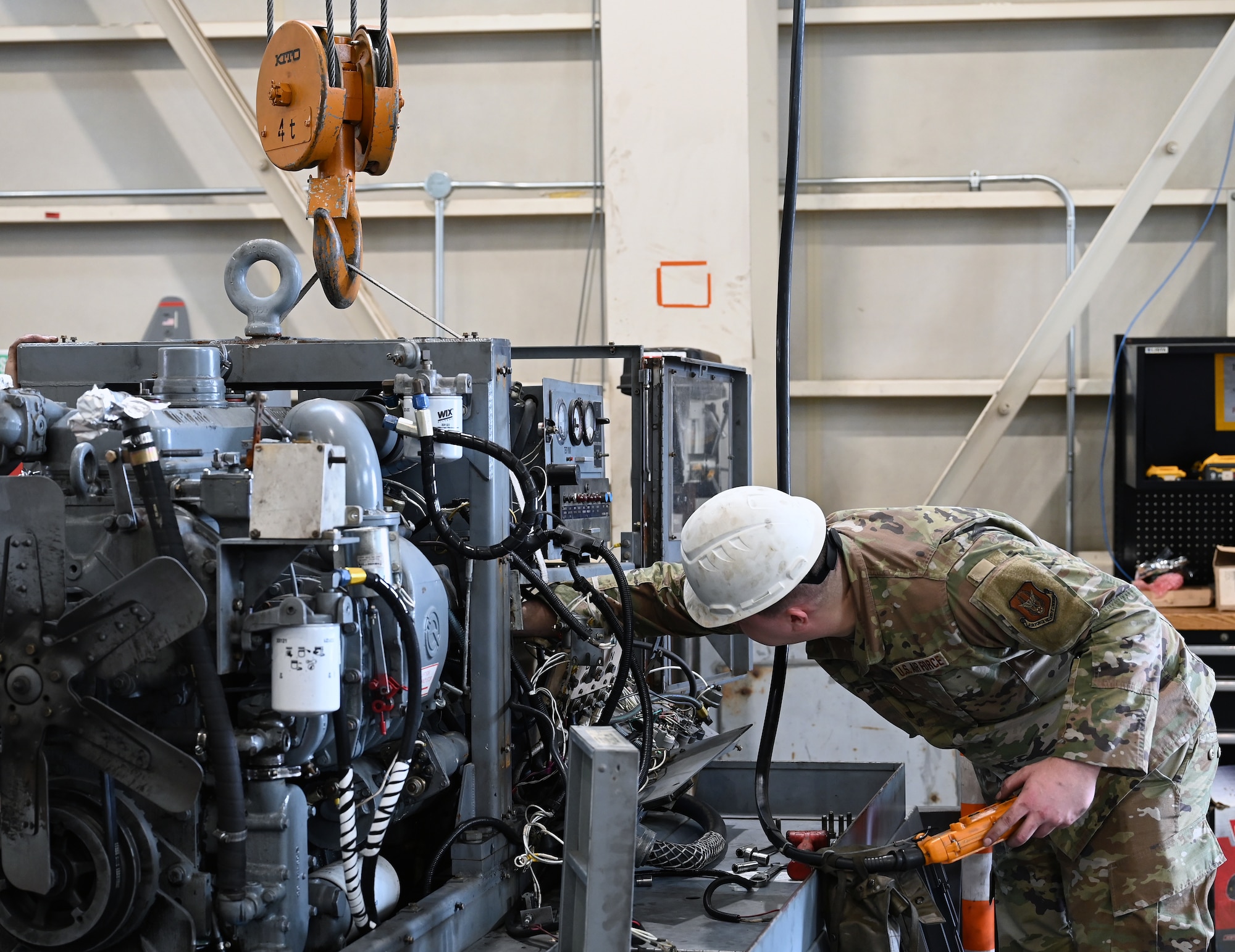 U.S. Air Force Tech. Sgt. Samuel Riddle, 445th Maintenance Squadron aerospace ground equipment craftsman, helps complete the three-day job of combining serviceable components from multiple damaged generators to produce a functioning generator ready to go into immediate service on the flightline at Yokota Air Base, Japan, April 14, 2025. Riddle assisted in the removal of the engine out of a damaged generator with no power, inserting that engine into a generator with no damage. This resulted in cost savings to the government, because otherwise both generators would have been disposed. (U.S. Air Force photo by Staff Sgt. Johnathan Quiñones)