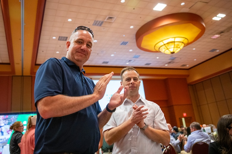 U.S. Army Corps of Engineers, Omaha District representatives (from left) Todd Tobias and Jeremy Szynskie, clap during the National Safety Council, Nebraska Chapter safety awards celebration, May 14, 2025, in LaVista, Nebraska.