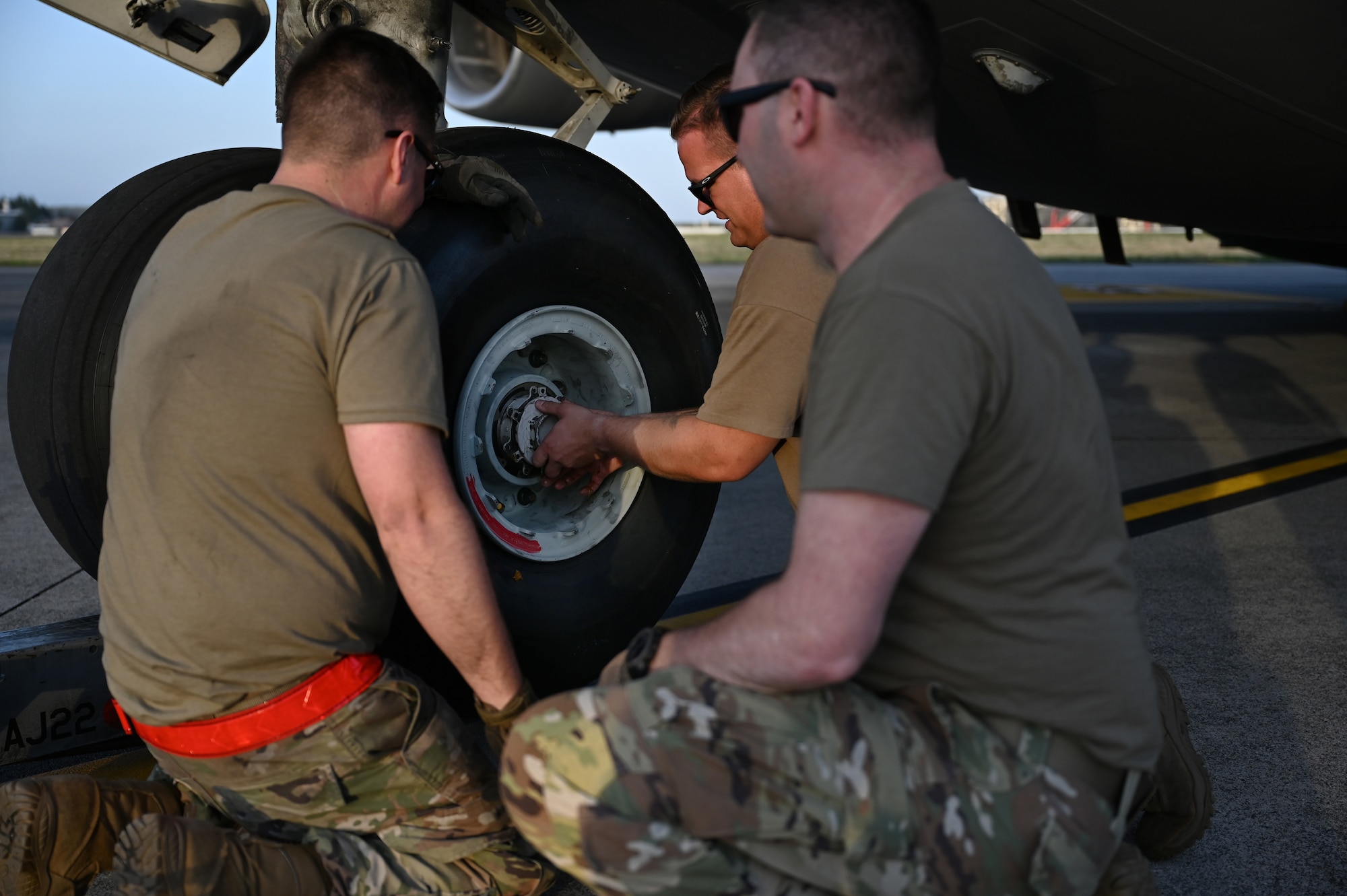 U.S. Airmen with the 445th Maintenance Squadron assist in the replacement of nose landing gear for a C-17 Globemaster III aircraft at Yokota Air Base, Japan, April 14, 2025. The landing gear was identified as beyond limits after conducting a thru-flight inspection. (U.S. Air Force photo by Staff Sgt. Johnathan Quiñones)