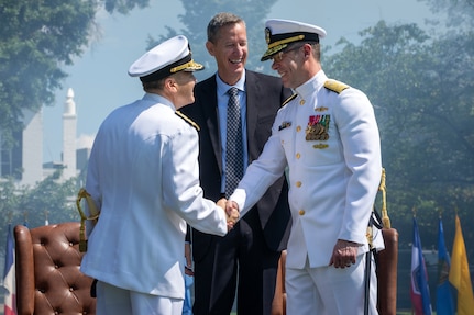 Rear Adm. Tom Anderson salutes sideboys alongside his wife during his retirement ceremony held at the Washington Navy Yard’s Leutze Park, May 30.