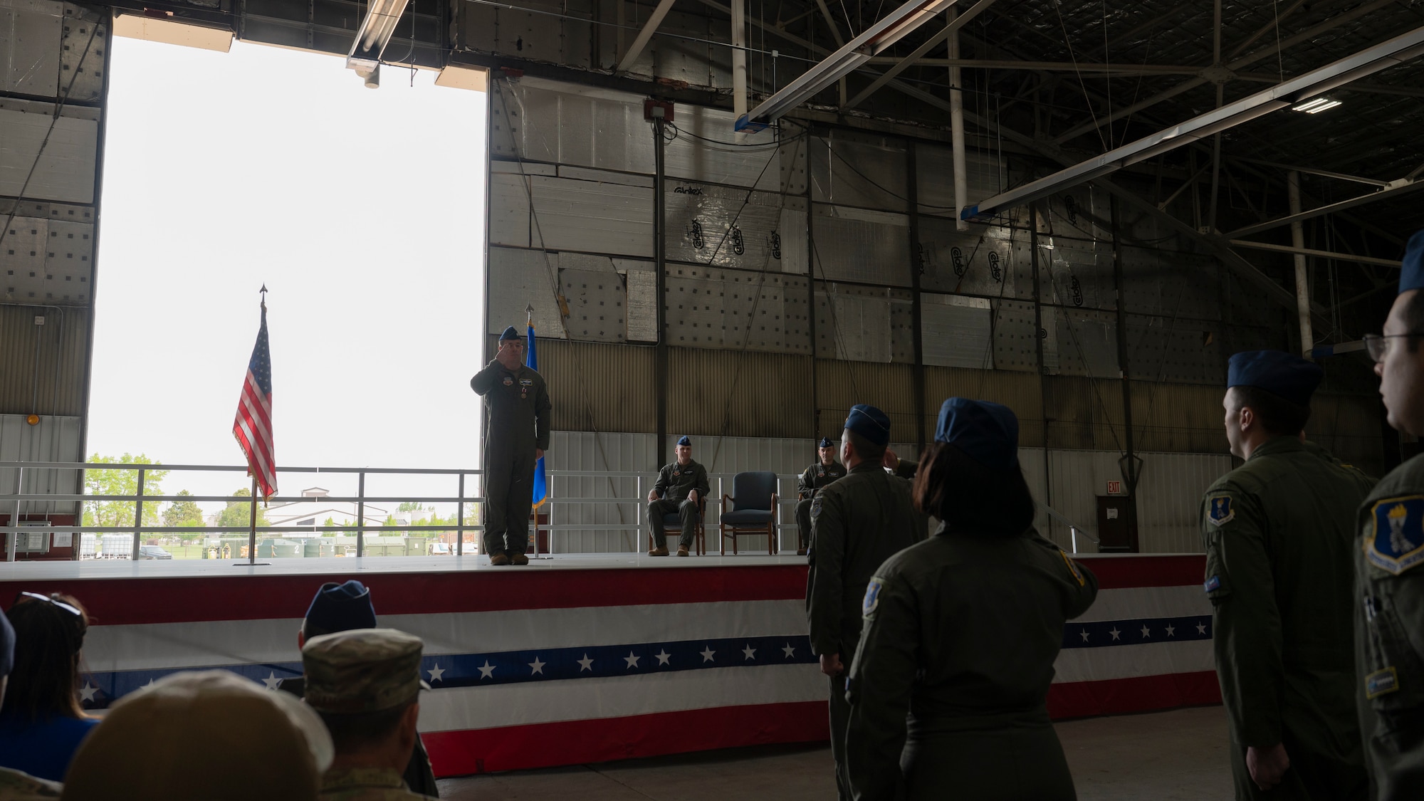Airmen from the 348th Reconnaissance Squadron salute Lt. Col. Cory Turner, outgoing 348th RS commander, during a change of command ceremony at Grand Forks Air Force Base, N.D., May 30, 2025. Turner was honored during the ceremony for his two years of service as the 348th RS commander. (U.S. Air Force photo by Airman Nailah Pacheco)