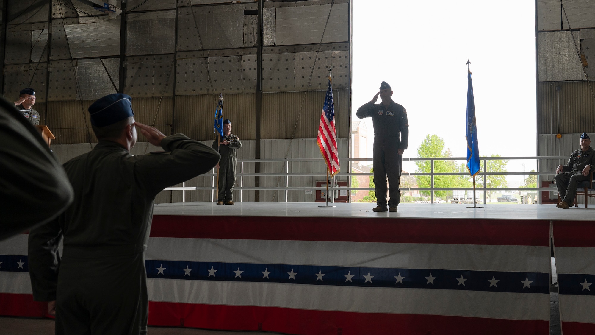 Airmen from the 348th Reconnaissance Squadron salute Lt. Col Robert Damron, 348th RS commander, during a change of command ceremony at Grand Forks Air Force Base, N.D., May 30, 2025. The 348th RS is responsible for managing and executing the RQ-4 Global Hawk Block 40 program, which provides high altitude, long endurance intelligence, surveillance and reconnaissance capabilities to support joint combatant forces. (U.S. Air Force photo by Airman Nailah Pacheco)