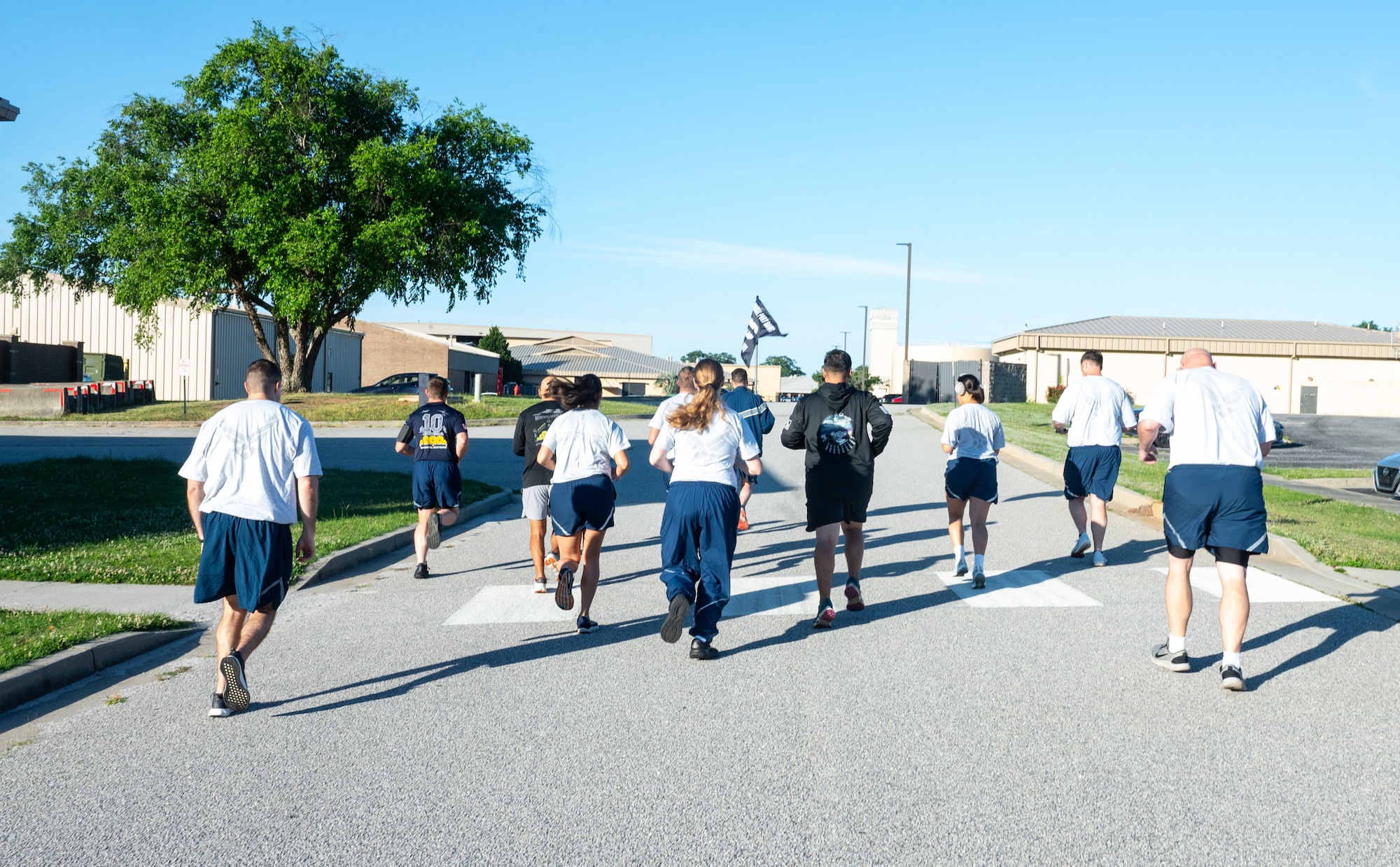 People begin to run outside on a road.