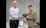 Capt. JD Crinklaw, commander, Puget Sound Naval Shipyard & Intermediate Maintenance Facility, presents Jason Cisler, work and systems design branch manager, Code 100TO, Transformation Office, with the Copernicus Award, May 5, 2025, at PSNS & IMF in Bremerton, Wash. (U.S. Navy photo by Wendy Hallmark)