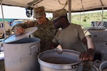 U.S. Army Staff Sgt. Jose Flores and Spc. Mouctar Kamara,140th Quartermaster Platoon, 169th Field Artillery Battalion, Colorado Army National Guard, prepare a meal for the Connelly Cup cooking competition at Fort Carson, Colorado, May 17, 2025. The 140th Quartermaster Platoon used the Connelly Cup cooking competition to build morale and demonstrate their unit capabilities. (U.S. Army National Guard Photo by Spc. Kyra Prahl)