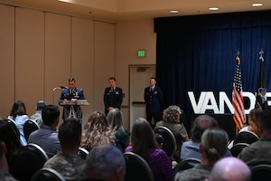 Salazar speaks at a podium to a crowd.