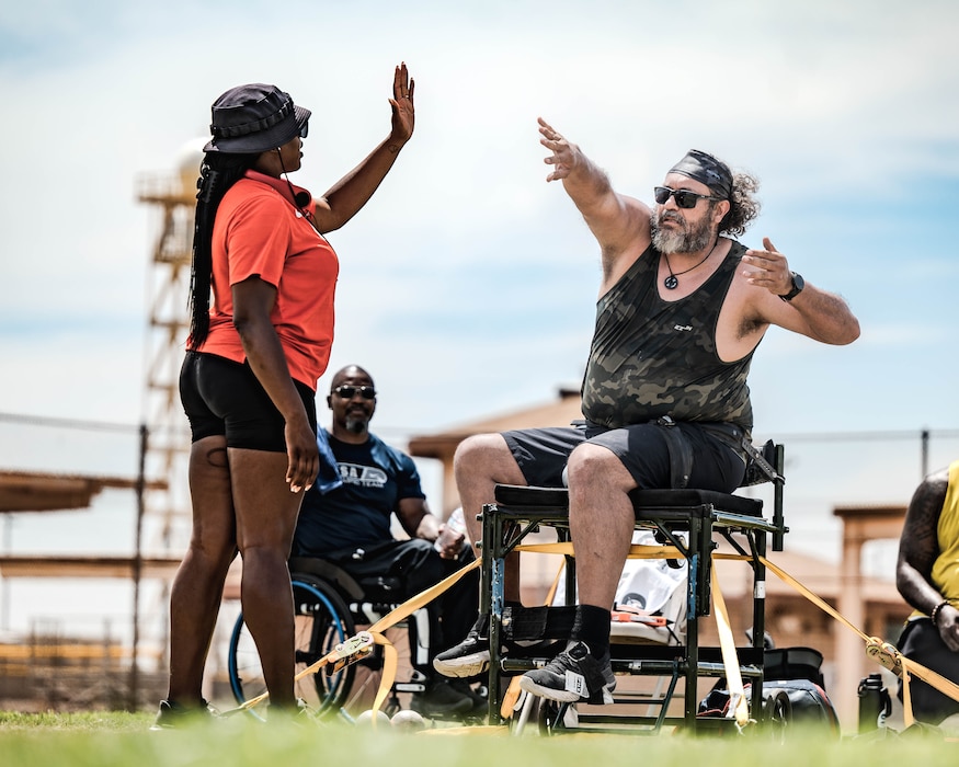 Coach Jasmine Burrell (left) and para-athlete Jesus Ontiveros (right) practice hand movement and techniques during Paralympics Training Camp