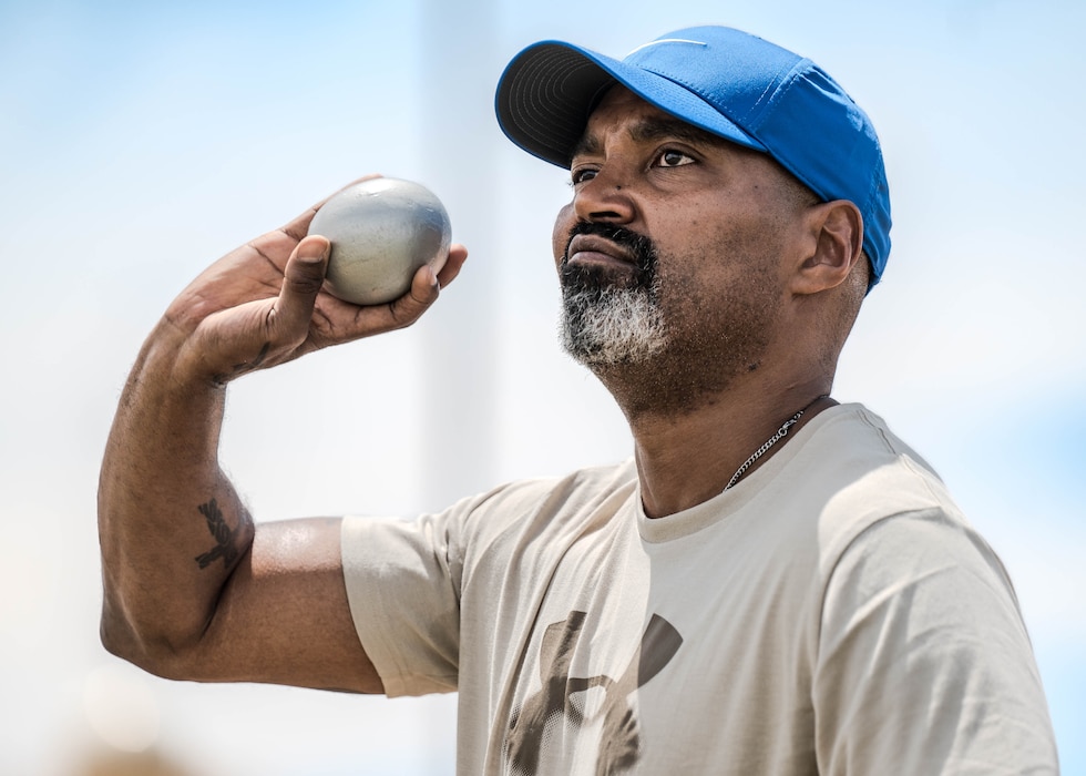 Para-athlete Christopher Francis tosses a medicine ball during Paralympics Training Camp