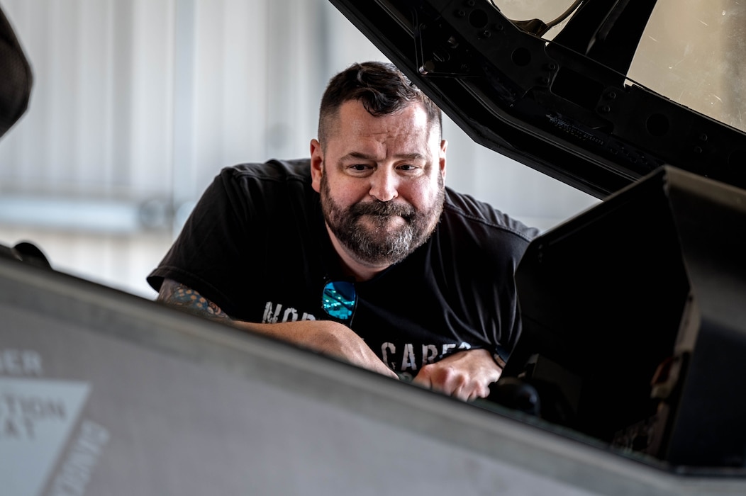 Para-athlete Dennis Bardelli views the inside of an F-35A Lightning II cockpit during a flightline tour