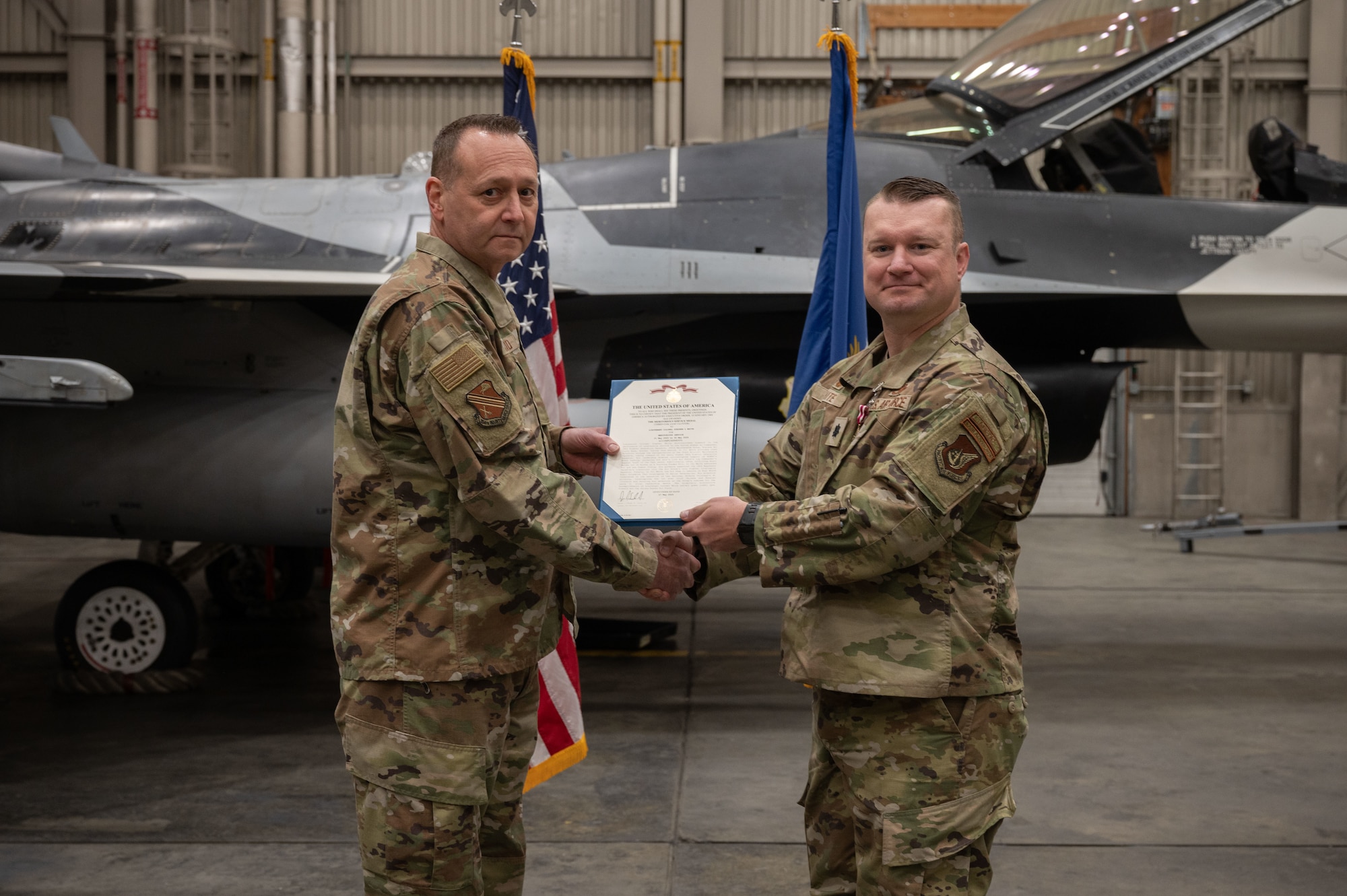 U.S. Air Force Lt. Col. Stephan White, right, 18th Fighter Generation Squadron outgoing commander, receives the Meritorious Service Medal from Col. Jerry Copeland, 354th Maintenance Group commander, during a change of command ceremony at Eielson Air Force Base, Alaska, May 30, 2025.