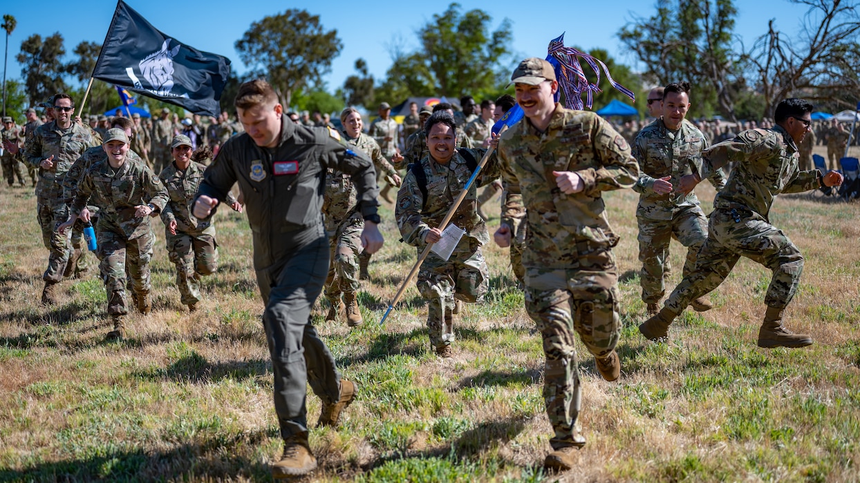 Many Airmen run toward the viewer