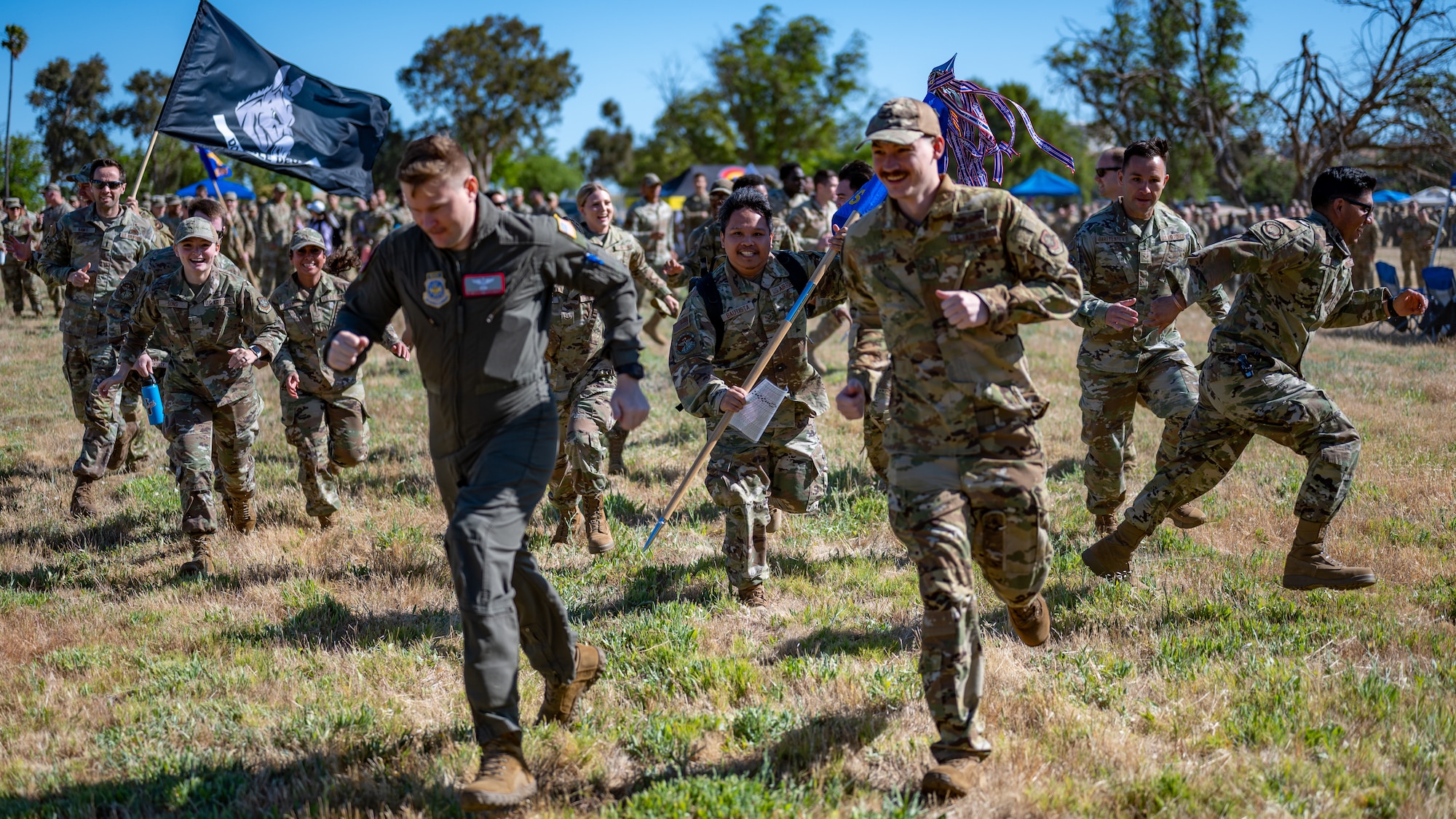 Many Airmen run toward the viewer