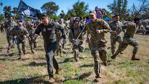 Many Airmen run toward the viewer