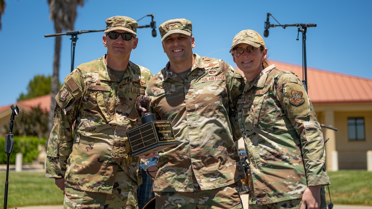 Airmen stand with an award