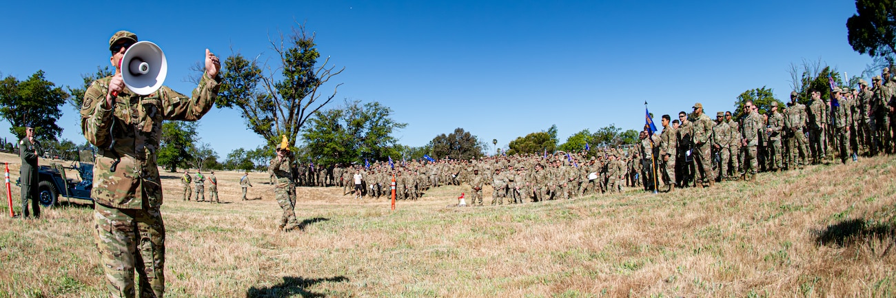 Col. Johnson speaks to Airmen with a megaphone