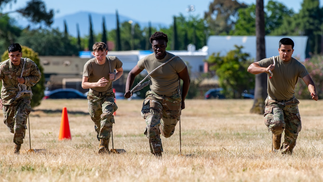 Four Airmen run toward the viewer