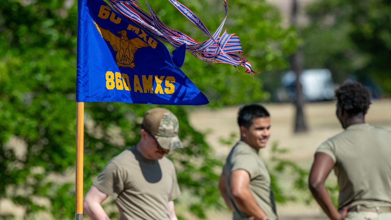 Airmen stand near guidon