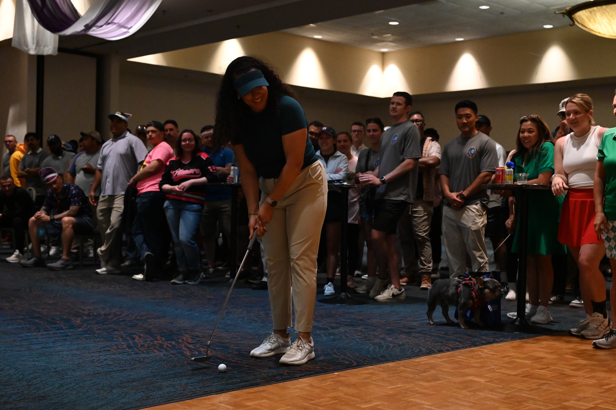 A person plays golf inside.