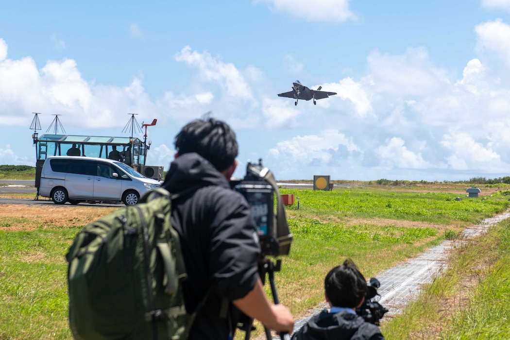 Japanese media representatives capture a U.S. Navy F-35C Lightning II assigned to Strike Fighter Squadron (VFA) 147 and attached to Carrier Air Wing (CVW) 5 as the aircraft conducts a “touch-and-go” during a field carrier landing practice (FCLP) at Iwo To, Japan, May 25, 2025.