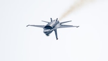 inverted F-16 fighter jet flies through the air
