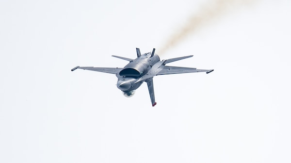 inverted F-16 fighter jet flies through the air