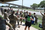 Frances Martinez, 960th CW director of psychological health, and other servicemembers arrives at the first rest station during the mental health awareness walk on JBSA-Lackland, Texas on May 3, 2025. (US Air Force photo by Alex Dieguez)