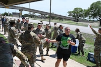 Frances Martinez, 960th CW director of psychological health, and other servicemembers arrives at the first rest station during the mental health awareness walk on JBSA-Lackland, Texas on May 3, 2025. (US Air Force photo by Alex Dieguez)