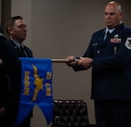 Senior Master Sgt. Jonathan Barron, Air Force Global Strike Command strategic deterrence and nuclear integration member, unwraps the new Detachment guidon at the Site Activation Task Force for Detachment 12. SATAF detachments are tasked with laying the groundwork for Sentinel support operations by overseeing and coordinating transition and establishment activities. (U.S. Air Force photo by Senior Airman Alexander Nottingham)