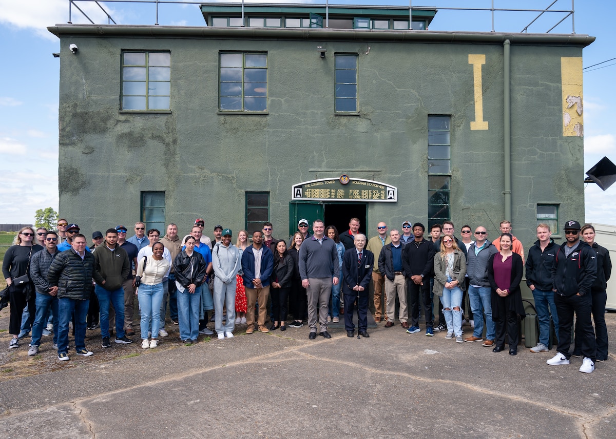 A group of people pose outside the restored Rougham Control Tower museum