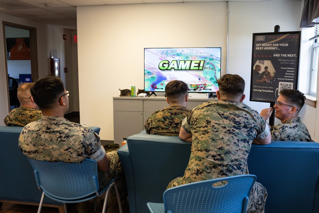 U.S. Marines with Fire Support Battalion, 10th Marine Regiment, 2d Marine Division, play videogames inside the USO of North Carolina on Marine Corps Base Camp Lejeune, May 15, 2025. Since relocating to its new base location, the USO has seen foot traffic increase to over 36,000 service members and families in 2024. (U.S. Marine Corps photo by Cpl. Loriann Dauscher)