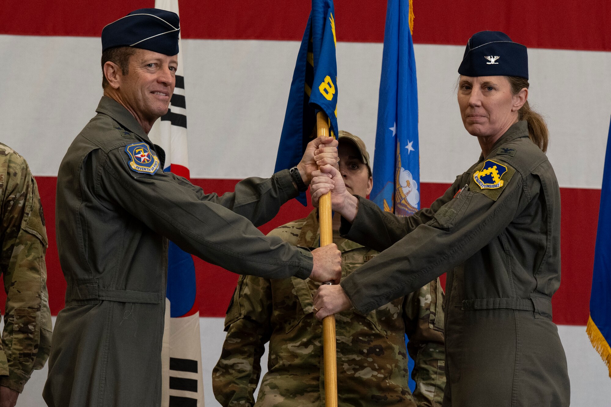 U.S. Air Force Col. Kathryn Gaetke, right, accepts command of the 8th Fighter Wing from Lt. Gen. David Iverson, 7th Air Force commander, during the 8th Fighter Wing change of command ceremony at Kunsan Air Base, Republic of Korea, May 30, 2025.