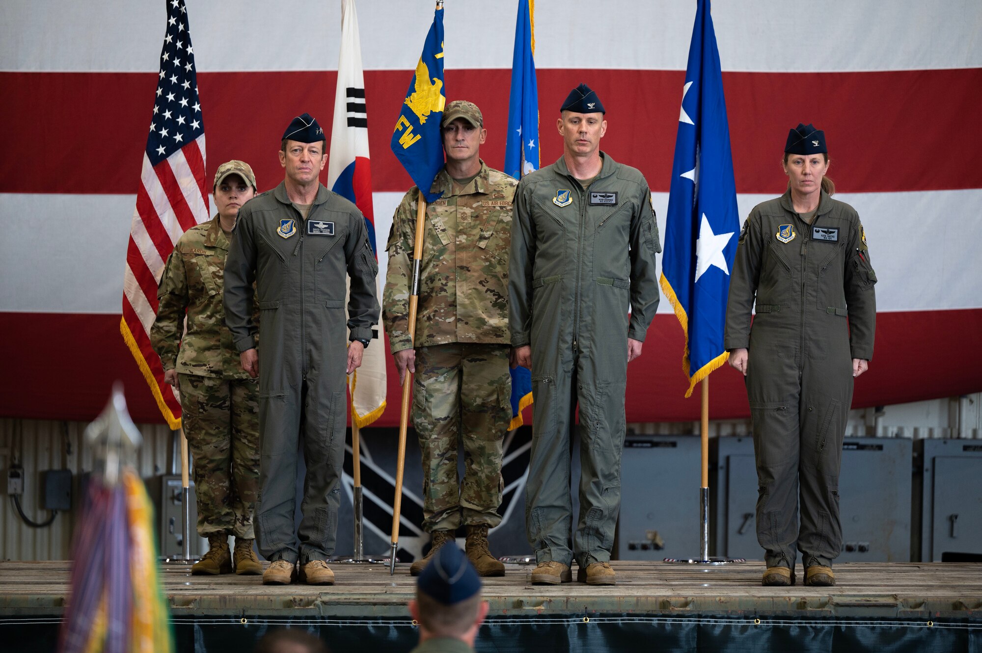 From left to right: U.S. Air Forces Chief Master Sgt. Amanda Aaron, incoming 8th Fighter Wing command chief, Lt. Gen. David Iverson, Seventh Air Force commander, Chief Master Sgt. Nathan Chrestensen, outgoing 8th Fighter Wing command chief, Col. Peter Kasarskis, outgoing 8th Fighter Wing commander, and Col. Kathryn Gaetke, incoming 8th Fighter Wing commander prepare to relinquish command from Col. Kasarskis to Col. Gaetke during a change of command at Kunsan Air Base, Republic of Korea, May 30, 2025.
