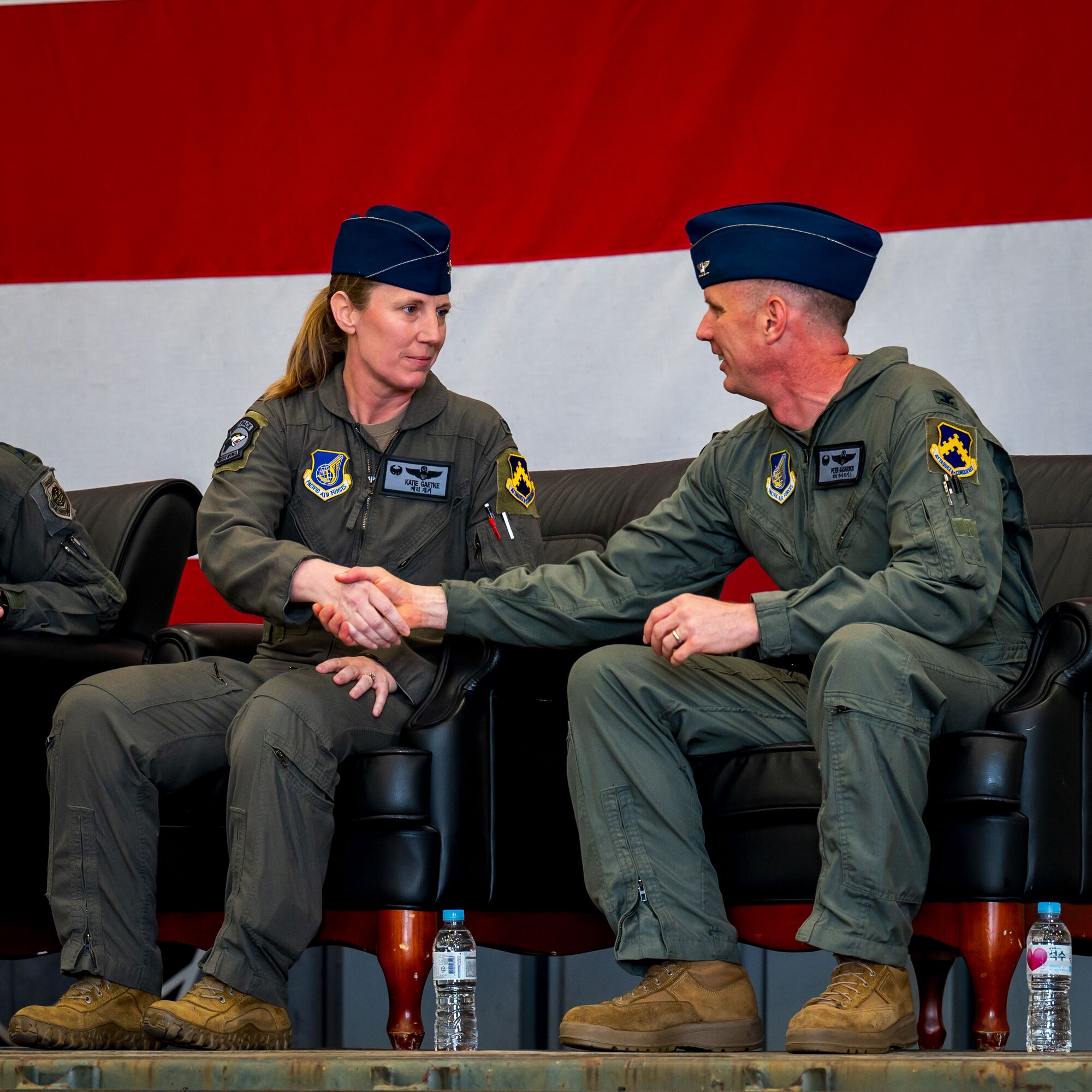 From left to right: U.S. Air Force Col. Kathryn Gaetke, 8th Fighter Wing commander, and Col. Peter Kasarskis, shake hands following their change of command ceremony at Kunsan Air Base, Republic of Korea, May 30, 2025.