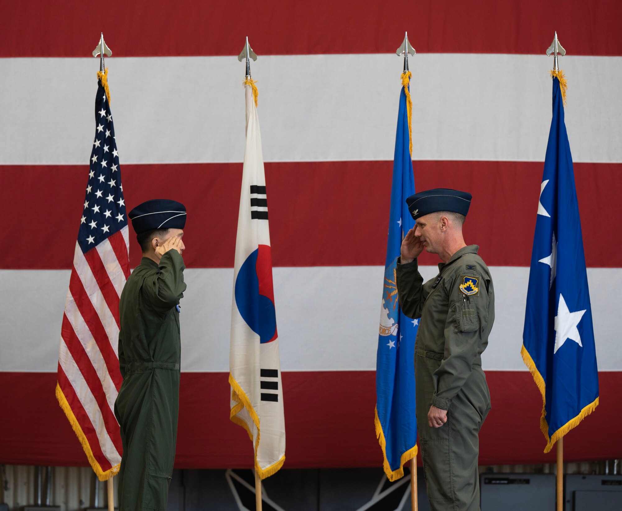 Republic of Korea Air Force Col. Yang - Jae, Ham, 38th Fighter Group commander, renders a final salute to U.S. Air Force Col. Peter Kasarskis, outgoing commander, during a change of command ceremony at Kunsan Air Base, Republic of Korea, May 30, 2025.