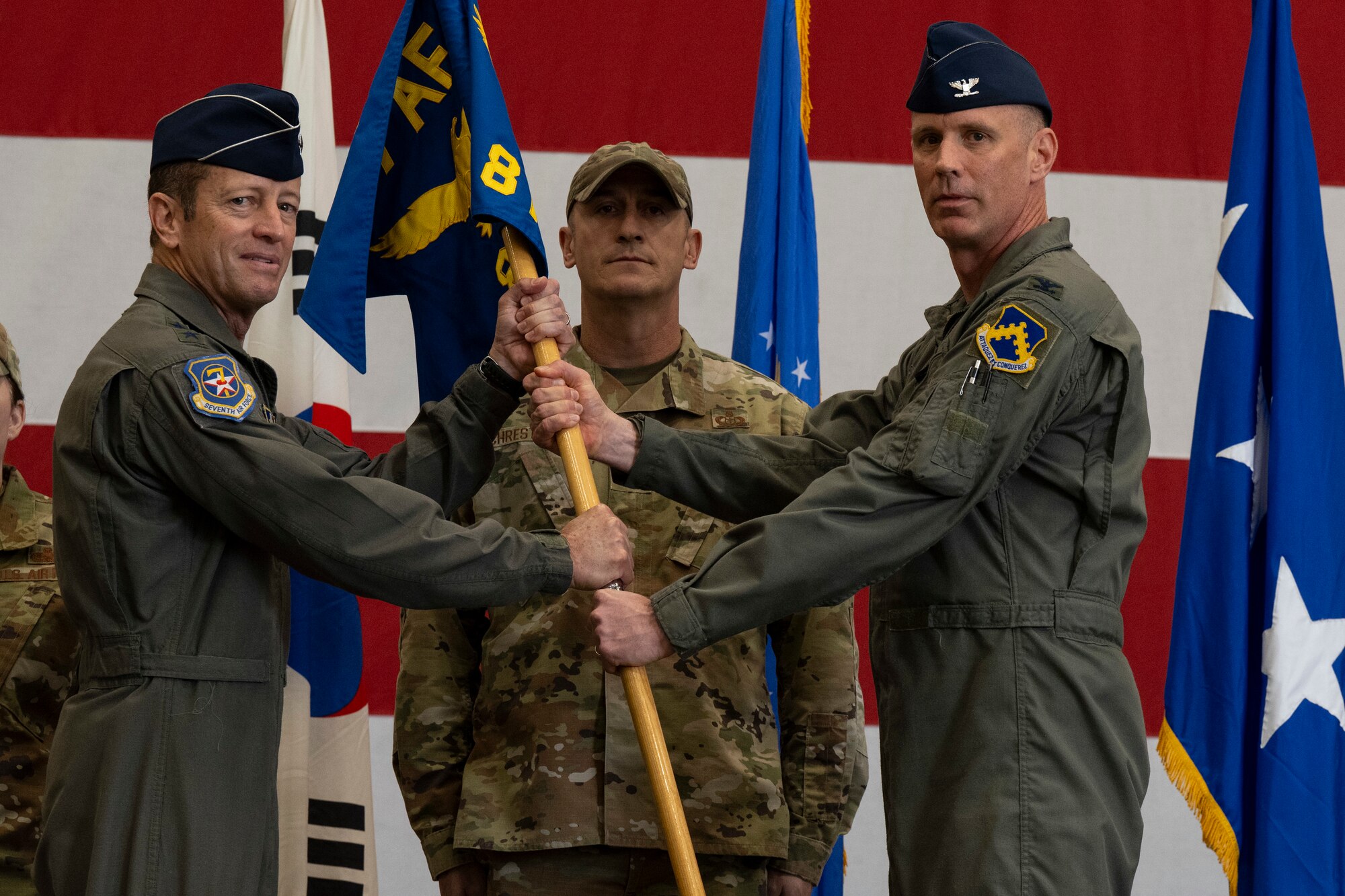 U.S. Air Force Col. Peter Kasarskis, right, relinquishes command of the 8th Fighter Wing to Lt. Gen. David Iverson, 7th Air Force commander, during the 8th Fighter Wing change of command ceremony at Kunsan Air Base, Republic of Korea, May 30, 2025.