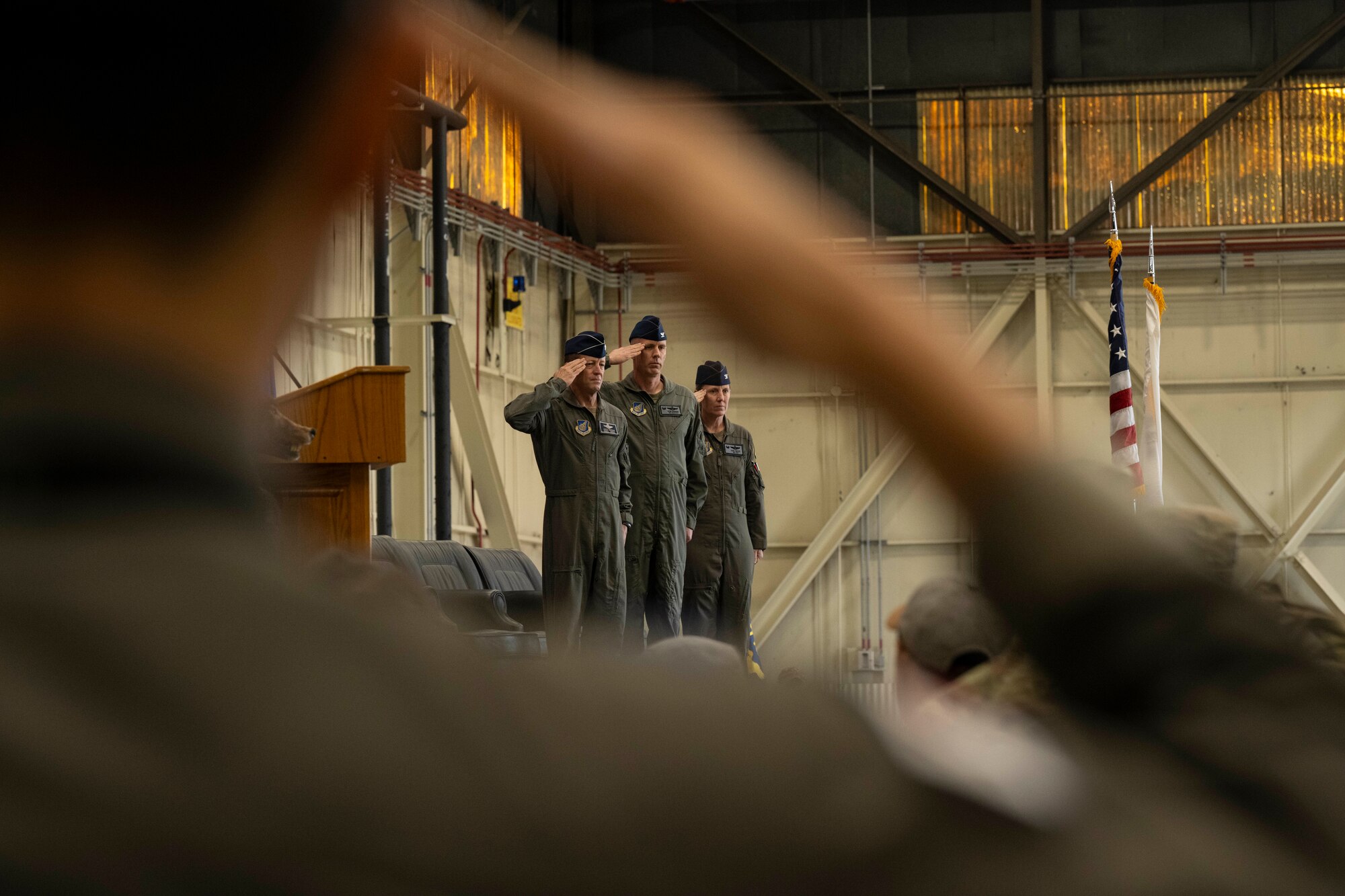 U.S. Air Force Lt. Gen. David Iverson, 7th Air Force commander, left, Col. Peter Kasarskis, and Col. Kathryn Gaetke, present arms during the playing of the U.S. National Anthem during the 8th Fighter Wing change of command ceremony at Kunsan Air Base, Republic of Korea, May 30, 2025.