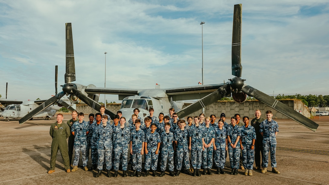 U.S.  Marines with Marine Rotational Force – Darwin 25.3 and Australian Air Force Cadets pose for a photo in front of a Marine Corps MV-22B Osprey during a tour at Royal Australian Air Force Base Darwin, Australia, May 22, 2025. The Marines aim to strengthen ties with the local Darwin community as well as increase the cadets’ understanding of the Marines of MRF-D. (U.S. Marine Corps photo by Cpl. Angelina Sara)