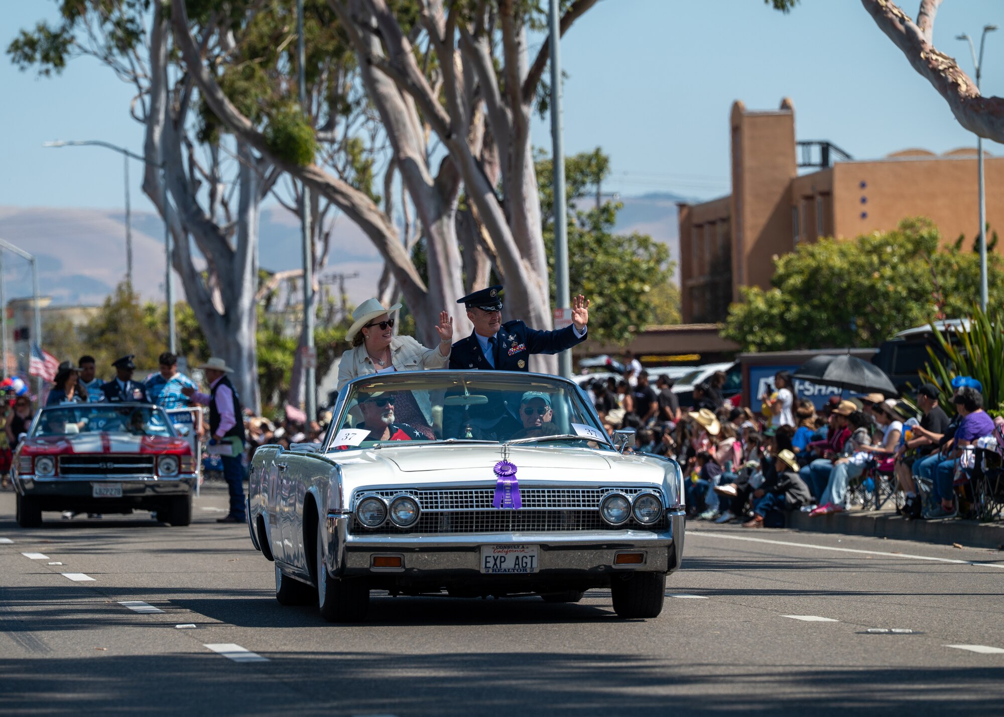 U.S. Space Force Col. Mark Shoemaker, Space Launch Delta 30 commander, and his wife Mary, wave to the crowd at the Santa Maria Elks Rodeo Parade in Santa Maria, Calif., May 31, 2025. VSFB leadership showed support for the surrounding community by participating in events through the weekend, commemorating 82 years of the Elks Rodeo. (U.S. Space Force photo by Senior Airman Ryan Quijas)
