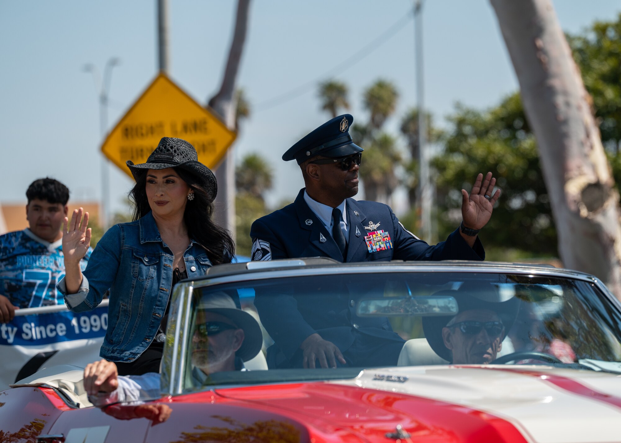 U.S. Space Force Chief Master Sgt. Jay Harris, Space Launch Delta 30 senior enlisted leader, right, and his wife Maria, waves to the crowd during the Santa Maria Elks Rodeo Parade in Santa Maria, Calif., May 31, 2025. VSFB leadership showed support for the surrounding community by participating in events through the weekend, commemorating 82 years of the Elks Rodeo. (U.S. Space Force photo by Senior Airman Ryan Quijas)