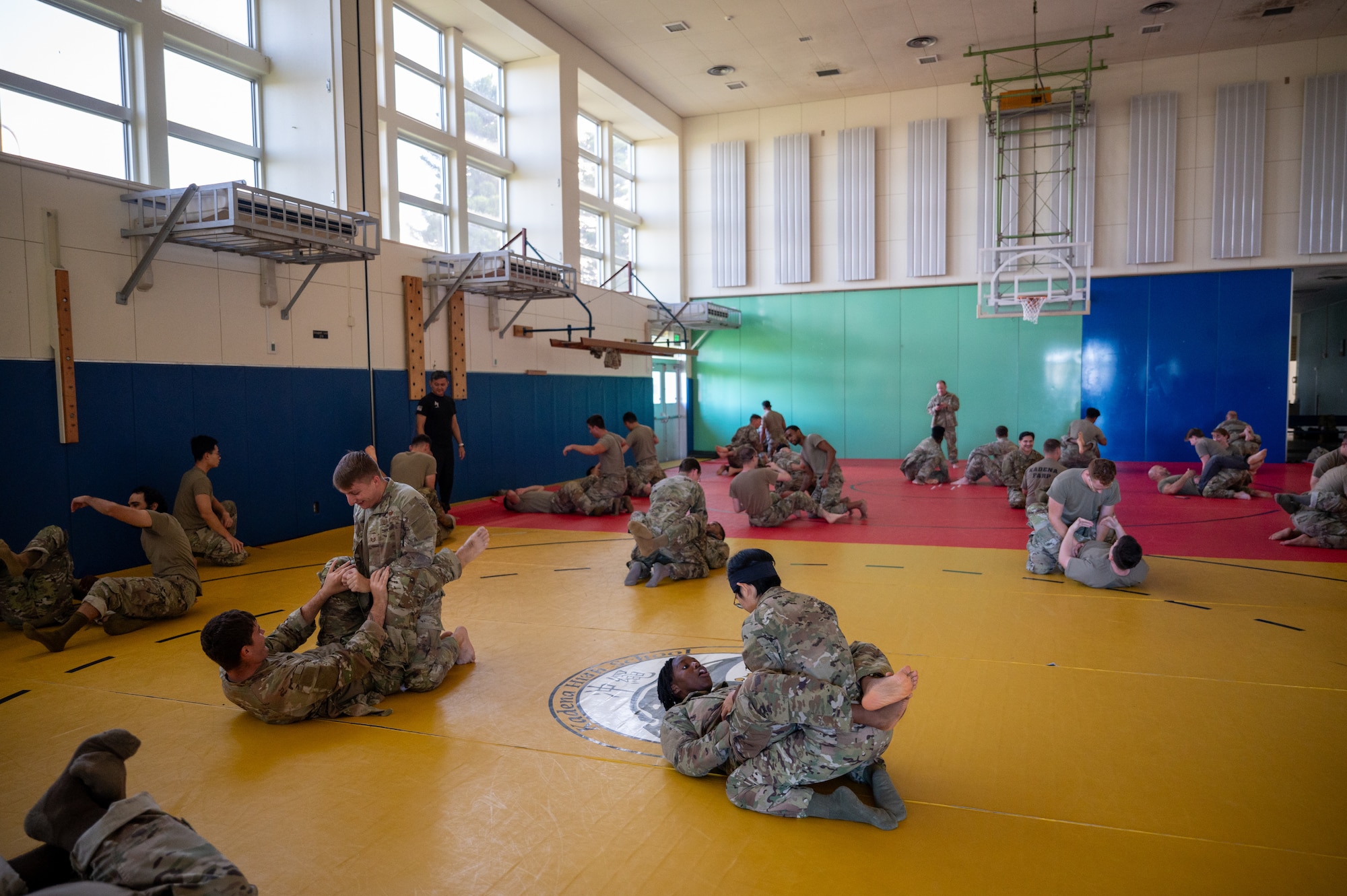 students practice combatives moves on one another