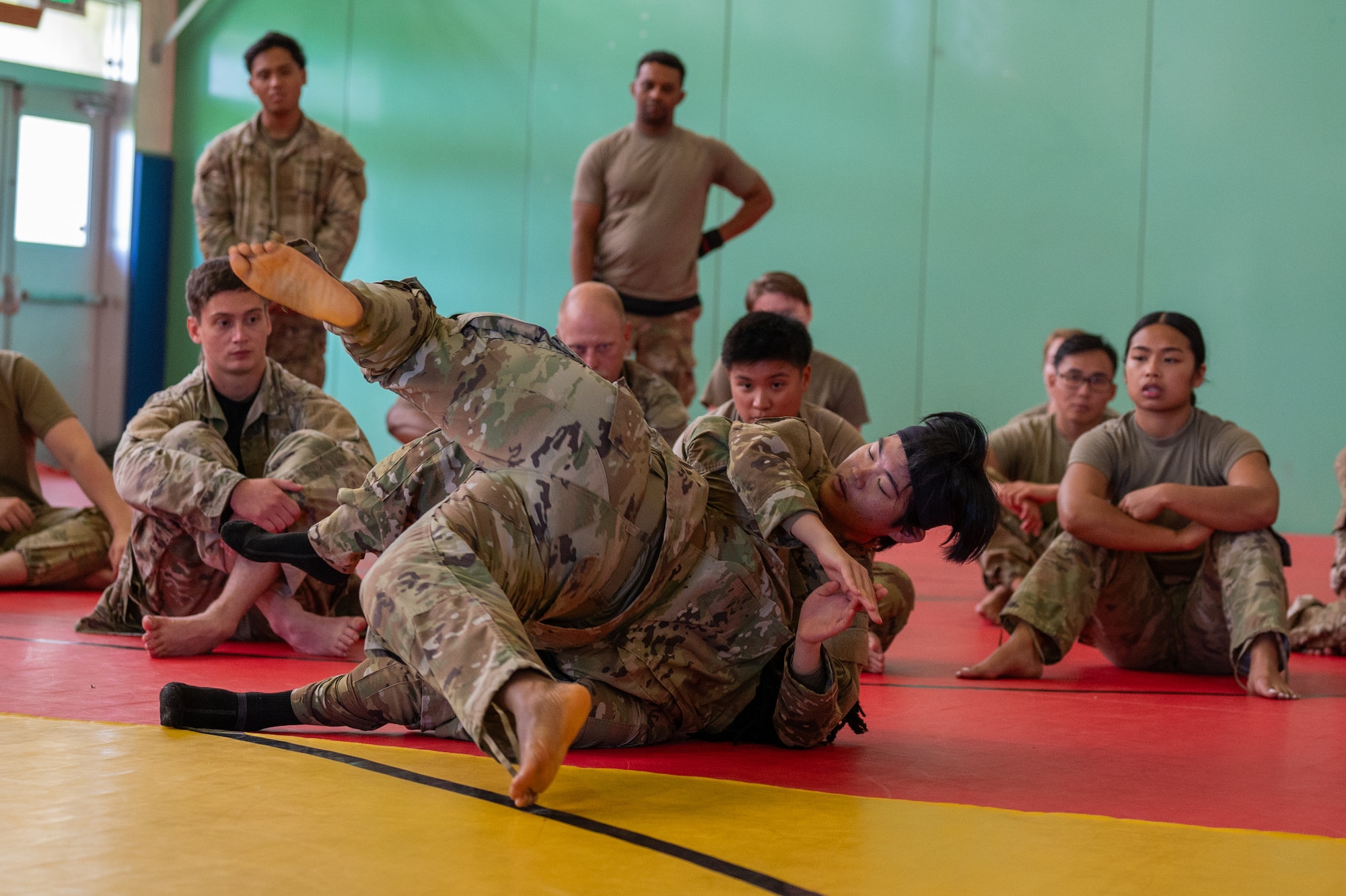 military members tumble during combatives course