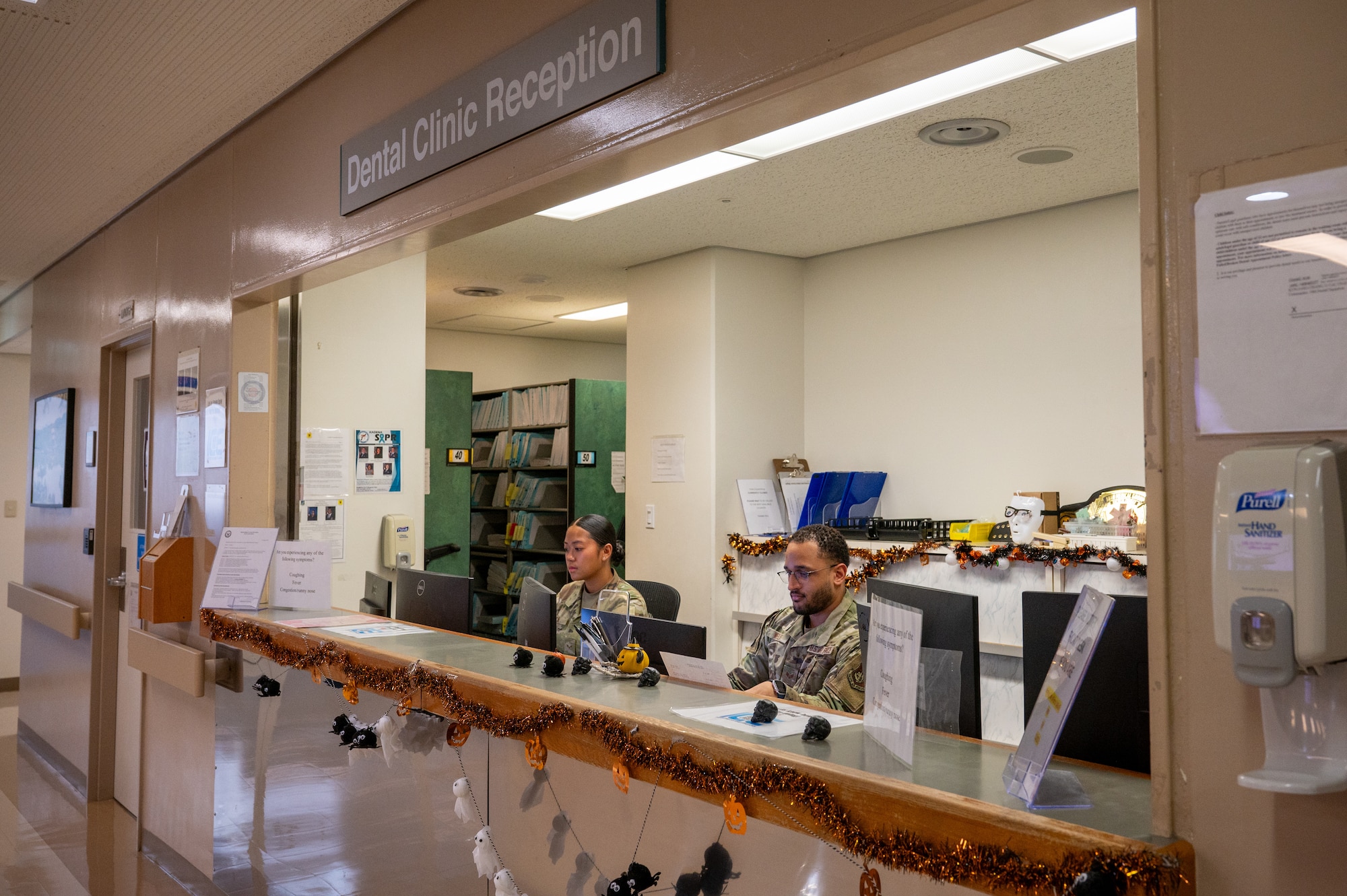 military members check in patients at the dental front desk