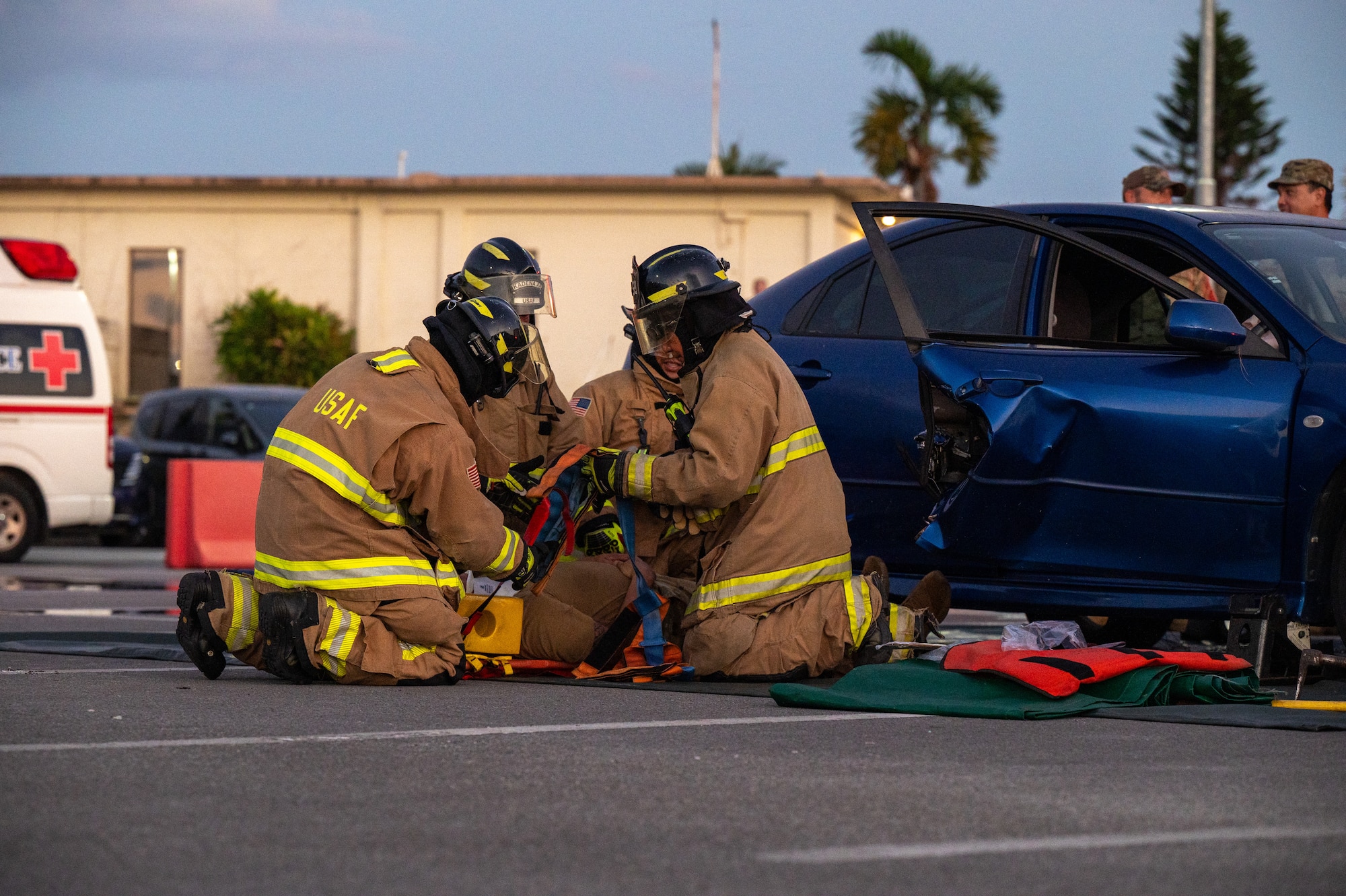 U.S. Air Force firefighters assigned to the 18th Civil Engineer Squadron extract a mock victim from a vehicle during a simulated accident as part of a Fire Prevention Week demonstration.