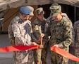 AL UDEID AIR BASE, Qatar (Nov. 3, 2025) Adm. Brad Cooper, commander of U.S. Central Command, right, cuts a ribbon with Chief of Staff of Qatar Armed Forces Lt. Gen. Jassim Al-Mannai during a ceremony at Al Udeid Air Base, Nov. 3. The event marked the opening of a new Combined Command Post for air defense staffed by personnel from Qatar and U.S. forces. (U.S. Air Force photo by Tech. Sgt. Chris Thornbury)