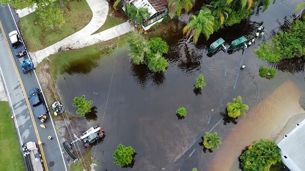 Eustis, Fla. – The U.S. Army Corps of Engineers (USACE), in coordination Lake County Emergency Management and state partners, has mobilized personnel to provide technical assistance with the ongoing flood response efforts in Lake County following recent heavy rainfall across the region. Workers can be seen laying out long suction hoses.( U.S. Army Photo by Brigida I. Sanchez)